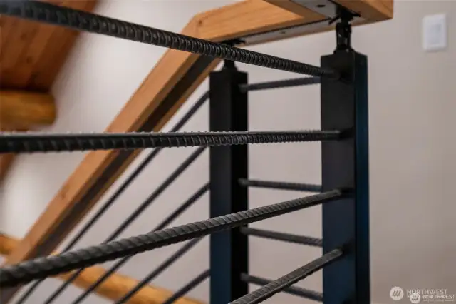 Rebar railing capped with 300+ year-old Douglas fir; reclaimed from the Skykomish river.