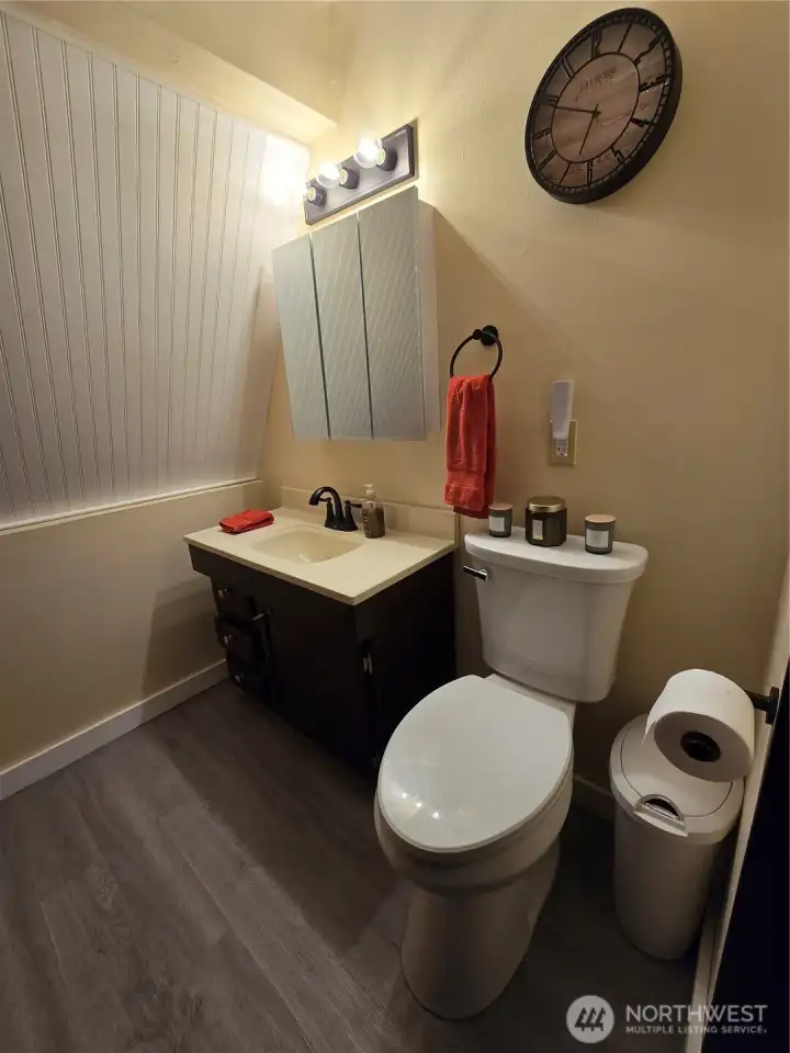 Cute beadboard accent wall, new vanity and toilet.