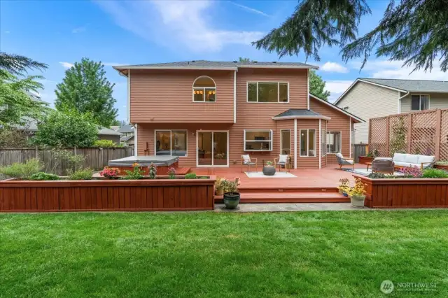 The lush backyard has been lovingly maintained with a mix of mature landscaping and new plantings