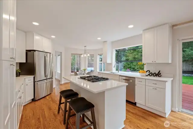 Kitchen island with natural gas range and down draft vent