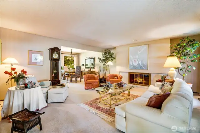 The cozy living and dining room, centered around a warm gas fireplace, offers a welcoming space for relaxing and entertaining.