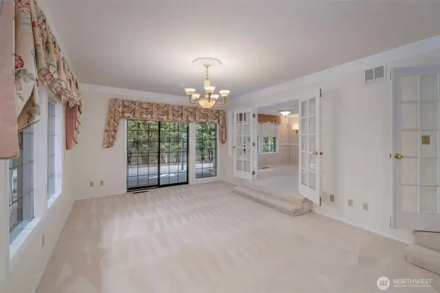 Living Room. with entrance to pool area and covered deck