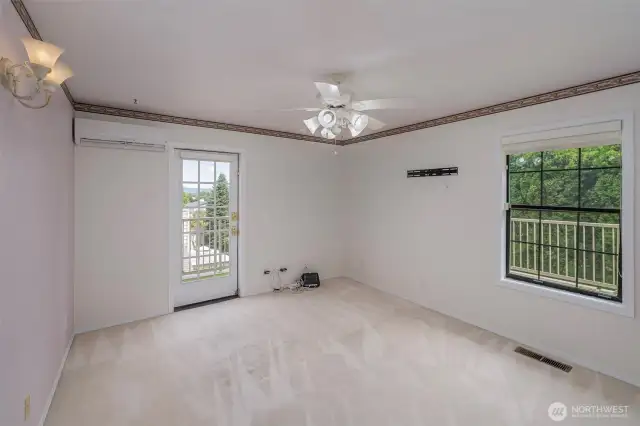 Guest Bedroom second floor with entrance to wrap around deck and putting area