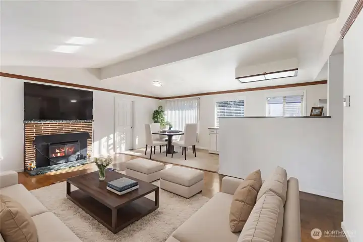 A look from the entry through the Living Room and into the Dining Room. Virtually staged.