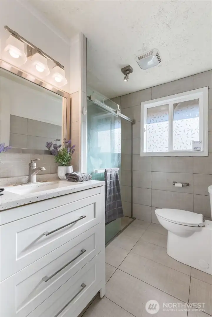 Remodeled Bath with new counter tops, flooring, cabinets.