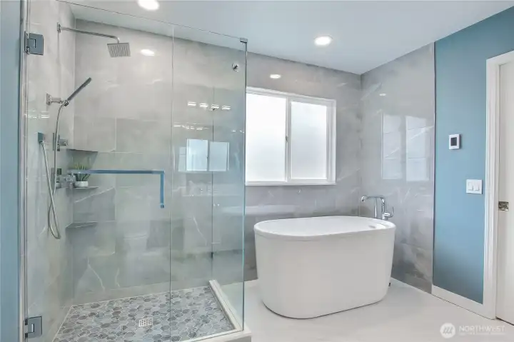 Huge glass encased walk in shower with soaking tub!