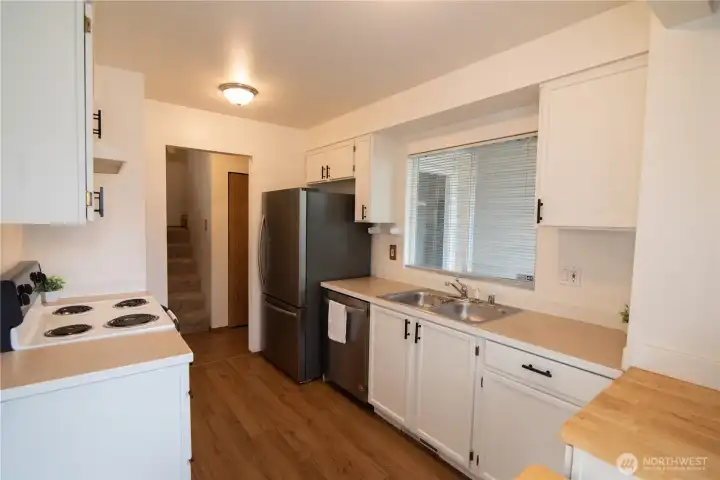 Light, bright kitchen with newer stainless fridge & dishwasher.