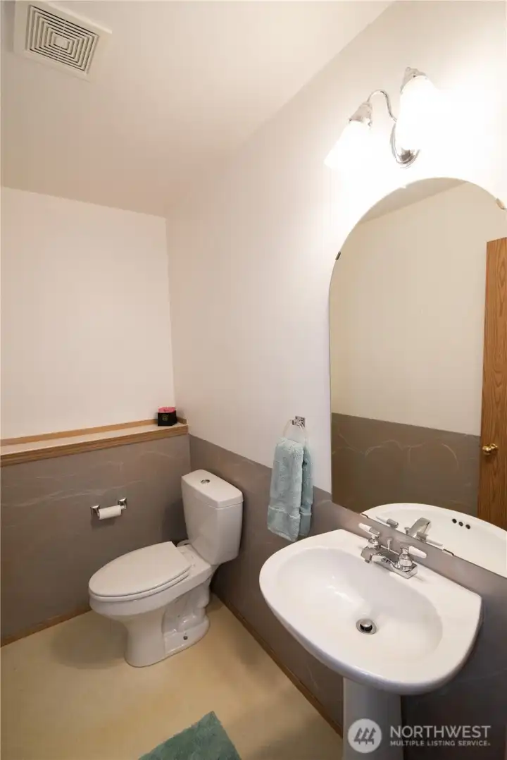 Main floor half bath with water saver toliet.