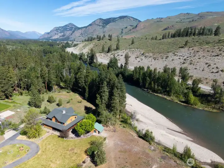 5.64 Acres is professionally landscaped with deciduous trees, bushes, wildflowers and more. Partially fenced yard includes Garden area and Garden shed. Explore the backyard meadow and walk the river trail.