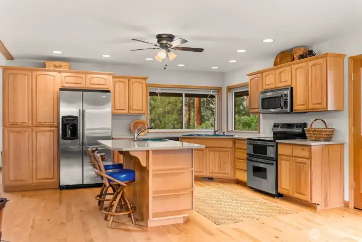 Kitchen is spacious. Lots of storage. Maple wood floor and cabinets blend seamlessly with the stainless Maytag appliances. Counter-tops are Silestone. Surface withstands heat and water famously. Double door refrigerator, D/W, Electric range and double-oven, Microwave. 2 Kitchen sinks. River views from Kitchen.