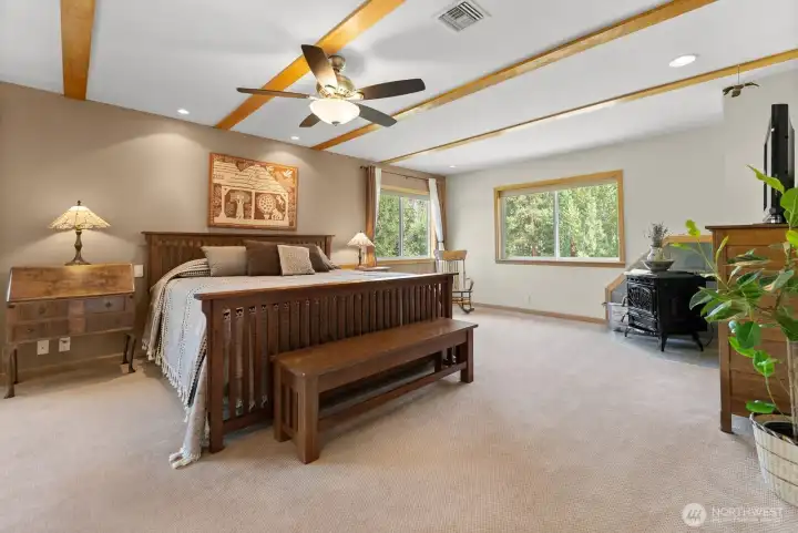 Upper Primary Bedroom is the essence of plush relaxation! Lots of natural light, Freestanding pellet stove for a winter warm glow.  Ceiling fan cools the summer breezes off of river at night. Ensuite bath enjoys custom Shower, Double sink vanity, Soaking tub, tiled floor. Walk-in closet. Plush carpet.