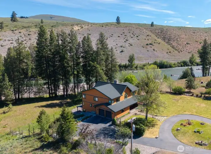 Asphalt driveway circles around the front of home and also goes to Garage and additional parking area.  Well planned building site.