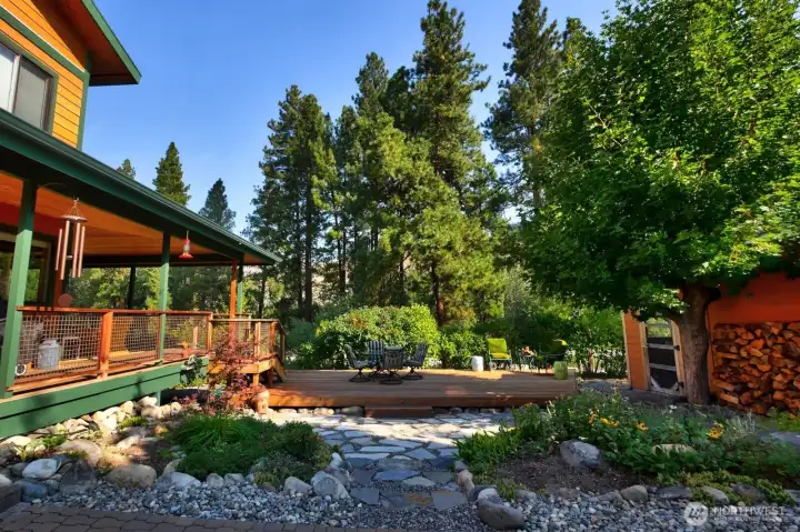 Afternoon setting amongst trees and flowering bushes on the East side of the home.