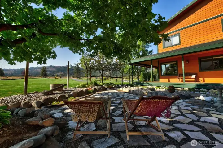 Mosaic patio under shade tree is a great spot to cool off and enjoy a good read.