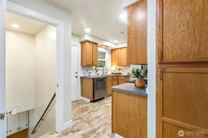 From the kitchen, stairs lead down to the basement From the kitchen, stairs lead down to the basement