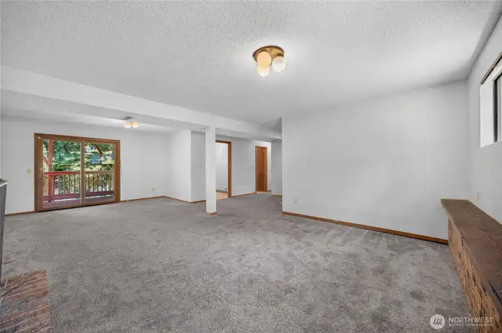 Family room with sliding glass door to deck