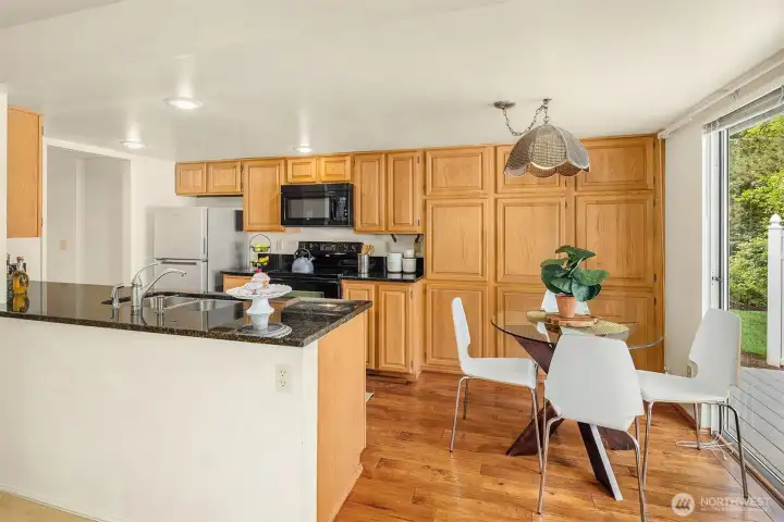 Kitchen with eating space and access to deck and the lovely landscape. Kitchen with eating space and access to deck and the lovely landscape.