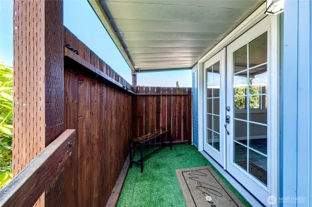 Welcoming front deck with French doors.