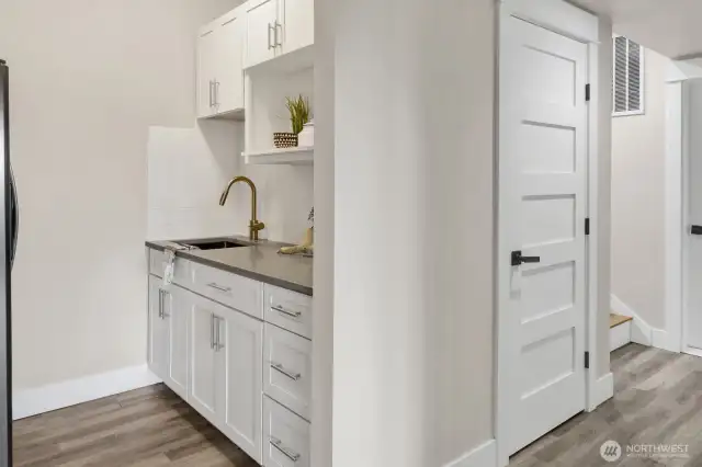 Downstairs kitchenette with full fridge.
