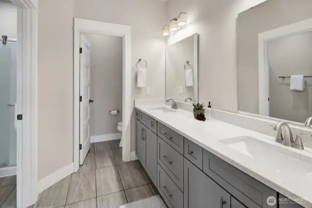 One of two mirror full bathrooms downstairs.
