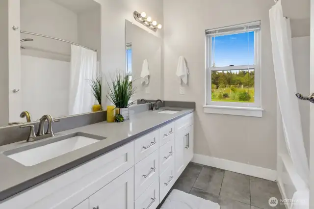 Fully bath in ADU with dual sinks.