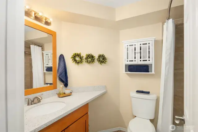 The full bath is centrally located, and directly across from the bedroom. Not shown is a large linen closet in hallway.