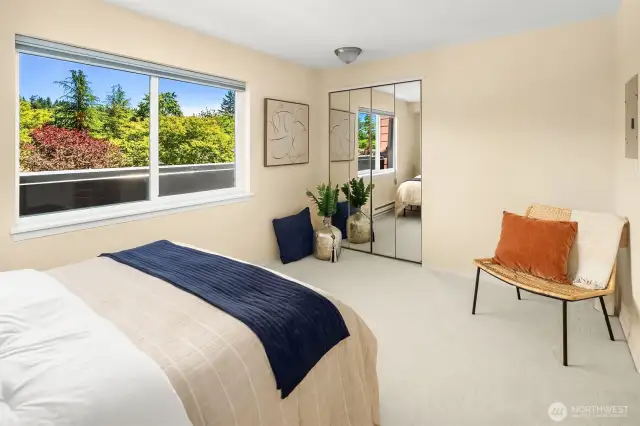 Another view of trees in spacious bedroom with one of two closets. The trees are beautiful with fall colors.