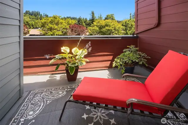The private deck is perfect for lounging, or possibly a nap with with a pretty view of the trees.