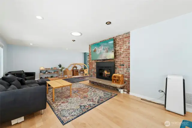 The hardwoods, big windows, tall ceilings, and brick fireplace feel like home.