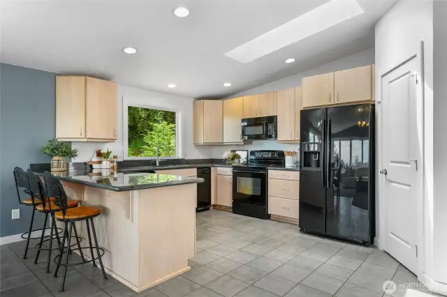 Large Skylight and oversized window provide ample light. Walk-in Pantry next to refrigerator.