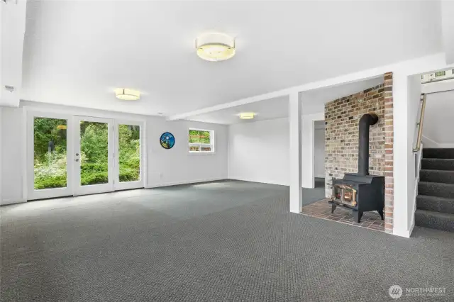 Lower Level Family Room with wood burning fireplace. Bedroom off Family Room and two ways to access Garage.