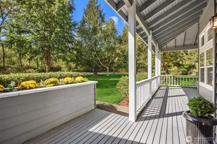 Charming wrap around porch offers another place to unwind and watch the squirrels at play