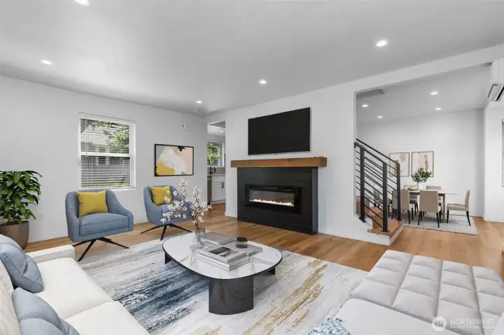 Sun-drenched and stylish with wide-plank flooring and a cozy electric fireplace. Virtually staged.