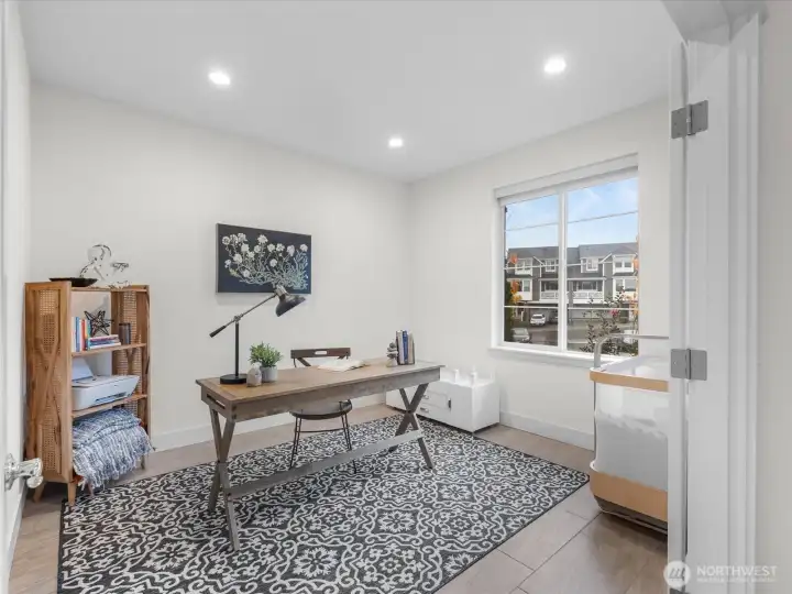 Office/Den with french doors grace the front entry.