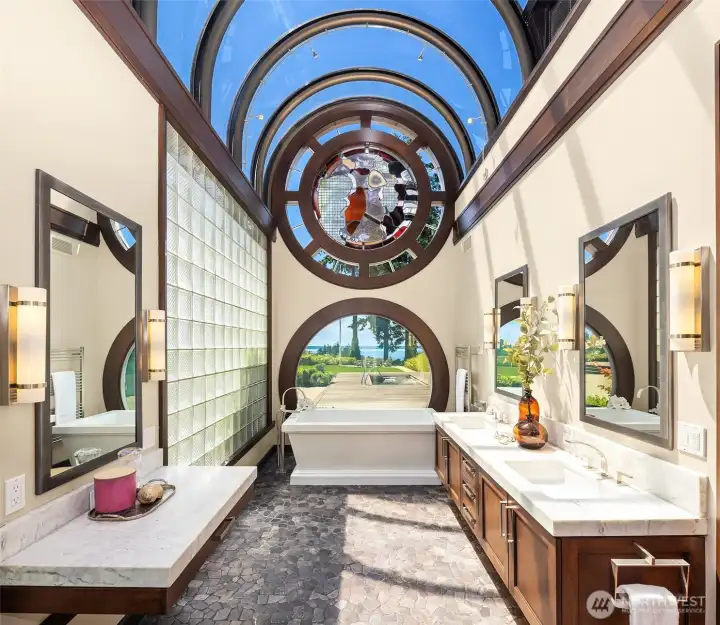 Spa inspired primary bathroom with privacy glass a the touch of a button. Heated stone floors.