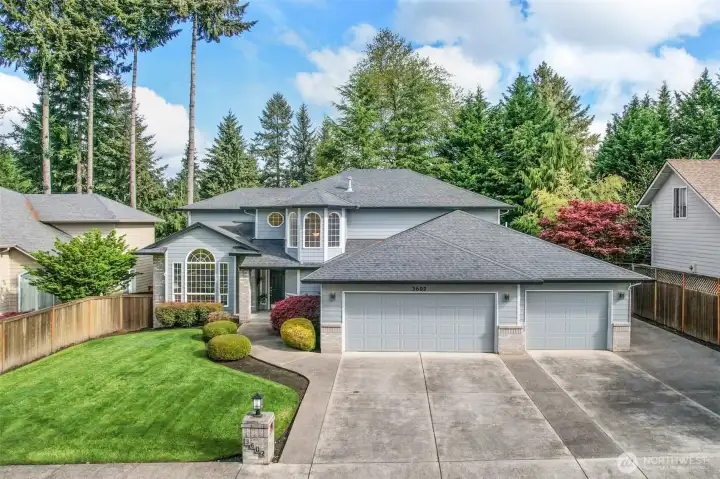 Straight on View of Front Yard, Flowering Shrubs, 3-Car Garage, Extra parking on right side