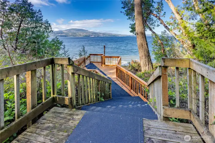 Brand new staircase with seating area and deck on beach.