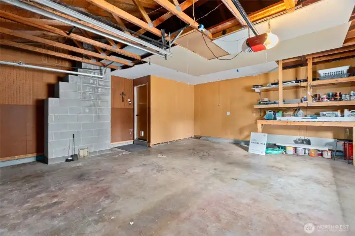 Large 2-car garage with attic ladder for extra storage in loft