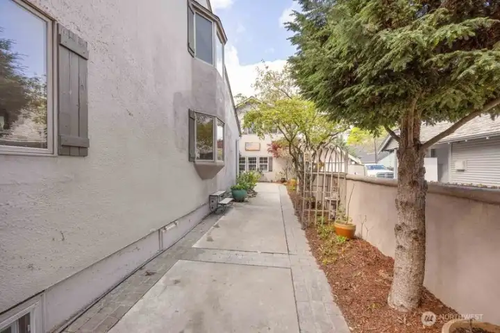 SIDE OF HOME WITH WIDE WALKWAY AND STUCCO WALL FOR PRIVACY TO BACK YARD