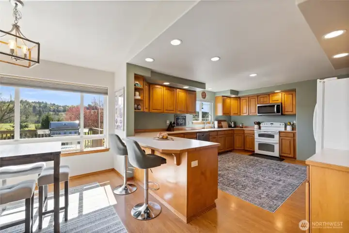 Versatile dining nook and at-counter eating spaces that overlook the deck and pasture.