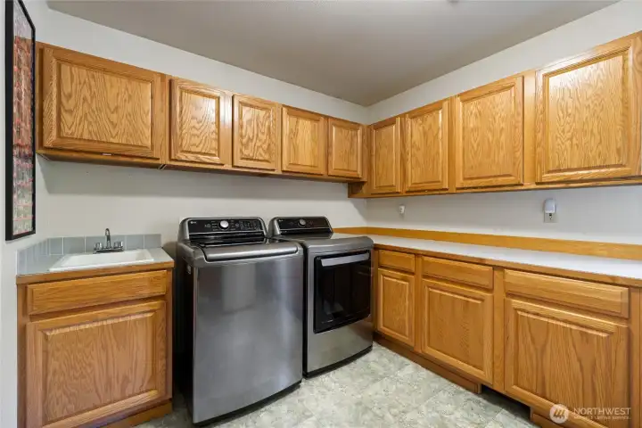 Utility room at the end of the main floor hall offers ample storage and a second refrigerator.