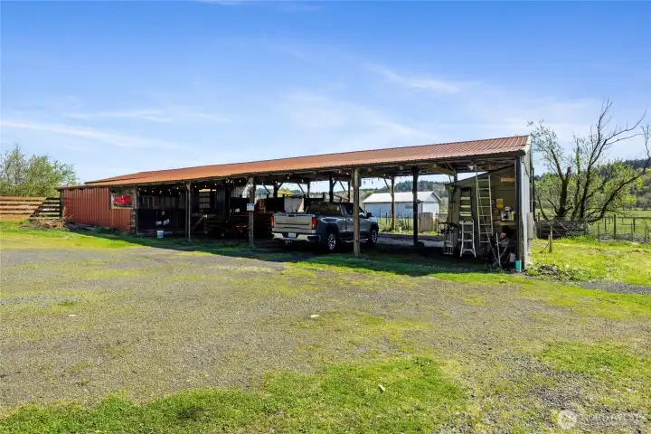 4,800 SF Barn offers a shop, livestock stall and staging gates, covered parking and storage.