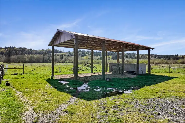 This midfield pole barn (2025 built) offers shelter and dedicated manure storage for pastured animals.