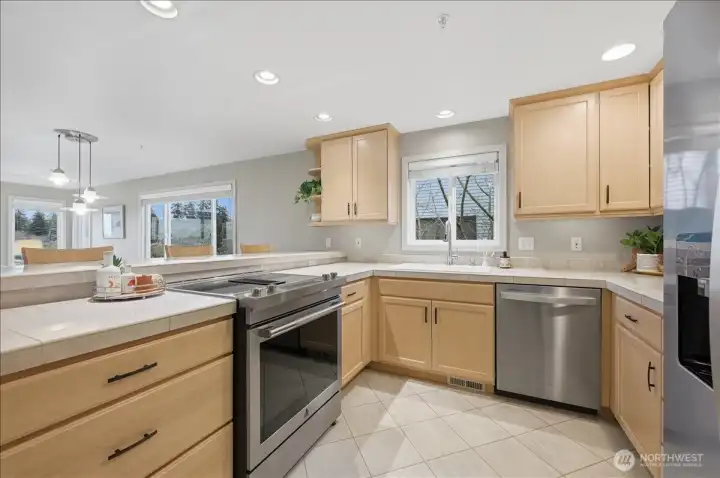 Bright kitchen with ample storage including a pantry (not pictured)