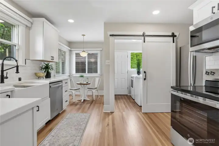 A sliding barn door adds character and leads to a convenient utility space, enhancing everyday livability. Just beyond, a charming breakfast nook tucked away in natural light offers the perfect spot for morning coffee or casual dining—private, cozy, and thoughtfully positioned for quiet moments. A sliding barn door adds character and leads to a convenient utility space, enhancing everyday livability. Just beyond, a charming breakfast nook tucked away in natural light offers the perfect spot for morning coffee or casual dining—private, cozy, and thoughtfully positioned for quiet moments.