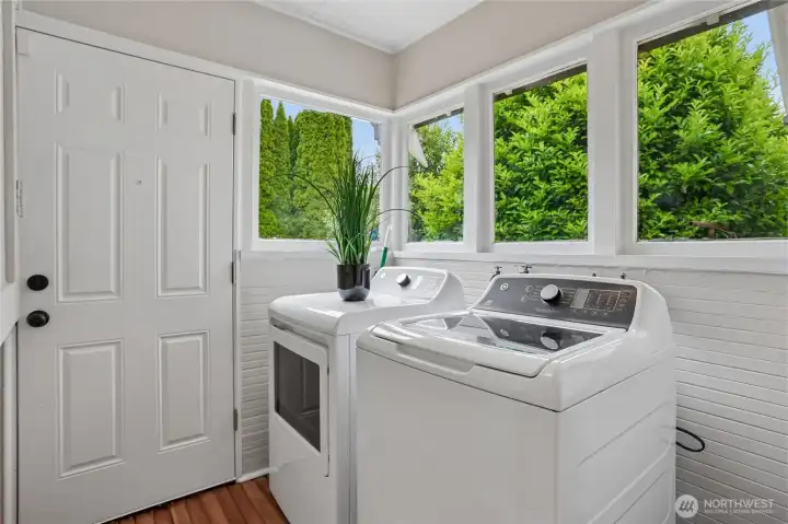 Just past the sliding barn door lies a vibrant utility area that showcases a brand-new GE washer and dryer set. This space combines a sleek design with modern efficiency and everyday convenience, all while being carefully concealed yet easily reachable. Just past the sliding barn door lies a vibrant utility area that showcases a brand-new GE washer and dryer set. This space combines a sleek design with modern efficiency and everyday convenience, all while being carefully concealed yet easily reachable.