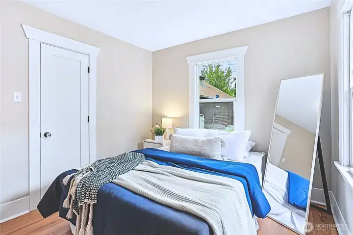 This bedroom boasts refurbished original hardwood floors and freshly painted walls and trim, resulting in a bright and pristine atmosphere. Careful attention to detail—including the closet door hardware—has been chosen to embody the home’s genuine 1920s Craftsman allure. This bedroom boasts refurbished original hardwood floors and freshly painted walls and trim, resulting in a bright and pristine atmosphere. Careful attention to detail—including the closet door hardware—has been chosen to embody the home’s genuine 1920s Craftsman allure.