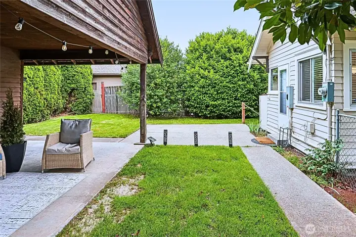 This inviting secondary outdoor space extends the home’s livability with a private patio and grassy area perfect for gathering. Whether you’re lounging on a sunny afternoon, hosting friends, or envisioning a cozy fire pit for roasting marshmallows under the stars, this space offers the flexibility to create your ideal backyard retreat. This inviting secondary outdoor space extends the home’s livability with a private patio and grassy area perfect for gathering. Whether you’re lounging on a sunny afternoon, hosting friends, or envisioning a cozy fire pit for roasting marshmallows under the stars, this space offers the flexibility to create your ideal backyard retreat.