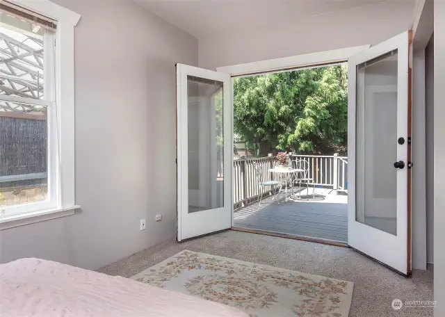 Bedroom doors open to private back deck and yard.