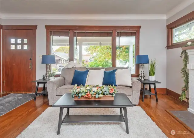 Large livingroom windows over looking the craftsman style porch.